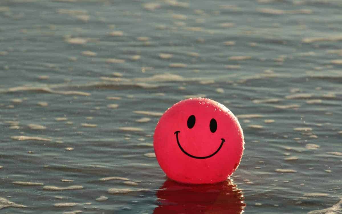 Red happy face ball in water